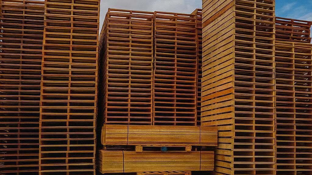 Stacks of repaired and recycled wooden pallets.